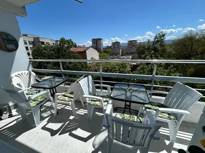 a group of chairs and tables on a balcony at MirrArt House - Просторен луксозен апартамент - 3 спални - 2 бани - Топ център in Plovdiv