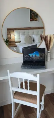 a laptop sitting on a desk in front of a mirror at MirrArt House - Просторен луксозен апартамент - 3 спални - 2 бани - Топ център in Plovdiv