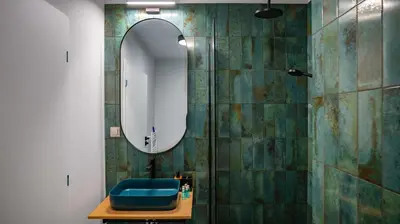 a bathroom with a blue toilet and a mirror at Aviva City Stay by Flat Mаnager in Sofia