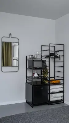 a black refrigerator with a mirror in a room at Aviva City Stay by Flat Mаnager in Sofia