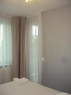 a bedroom with a bed and a window at Apartment 13 in Sofia