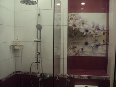 a shower with a glass door in a bathroom at Apartment 13 in Sofia