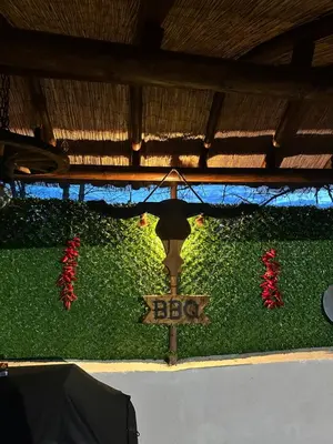 a sign that says bbb on a green wall with red flowers at Къща за гости Падалото in Smolyan