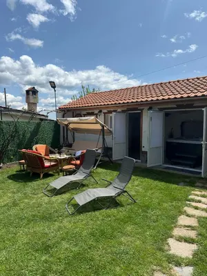 a yard with chairs and a table and a patio at Къща за гости Падалото in Smolyan