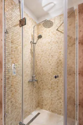 a bathroom with a shower with a glass door at Stylish and cosy Gem, top center! in Sofia