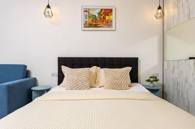 a bedroom with a bed with a black headboard and pillows at Maritsa 1BD Apartment by Flat Manager in Plovdiv