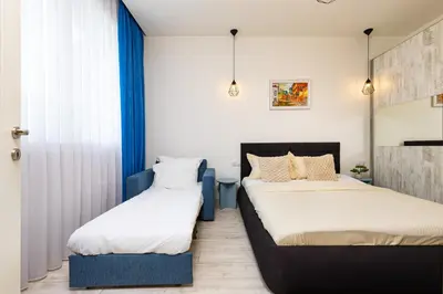 two beds in a room with blue and white at Maritsa 1BD Apartment by Flat Manager in Plovdiv