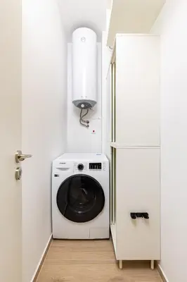a washing machine in a white laundry room with a refrigerator at Magnolia Gardens -1BD with Balcony & Parking by Flat Mаnager in Plovdiv