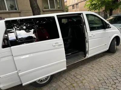 a white van with its doors open on a street at Трансфери in Plovdiv