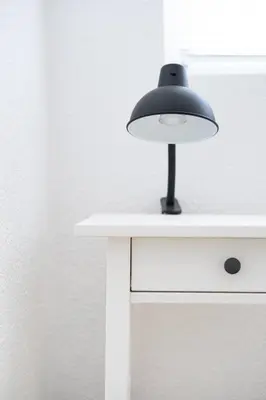 a black lamp sitting on top of a white table at Студио Черно и Бяло in Sandanski