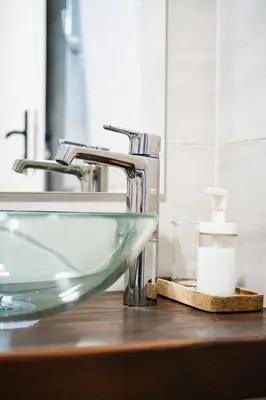 a sink in a bathroom with a glass bowl at Студио Черно и Бяло in Sandanski