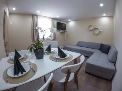 a living room with a table and a couch at Guest Rooms Lencho in Anton