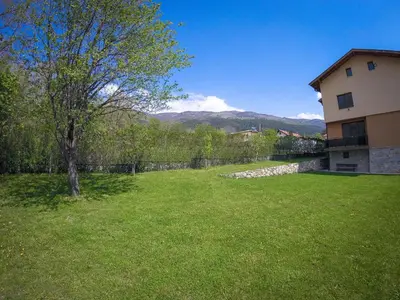 a yard of a house with a tree and a building at Guest Rooms Lencho in Anton