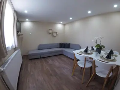 a living room with a couch and a table at Guest Rooms Lencho in Anton