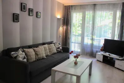 a living room with a couch and a coffee table at Apartment Near NDK Biairbnb in Sofia