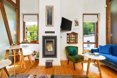 a living room with a blue couch and a fireplace at Old Town 2BR Spacious House with Private Garden and Free Parking in Plovdiv