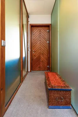 an empty hallway with a wooden door and a trunk at Old Town 2BR Spacious House with Private Garden and Free Parking in Plovdiv