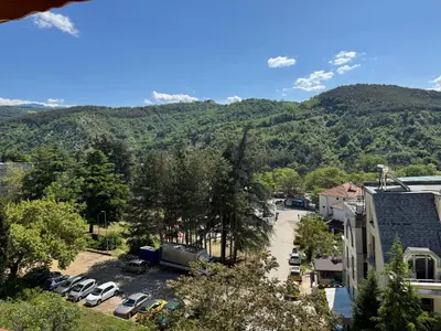 a view of a city with cars parked in a parking lot at United Apartments 3 in Sandanski