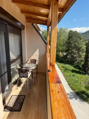 a patio with a table and chairs on a balcony at United Apartments 3 in Sandanski