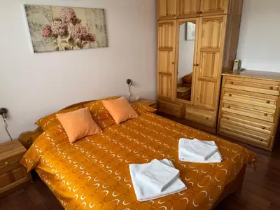 a bedroom with a bed with two towels on it at United Apartments 3 in Sandanski