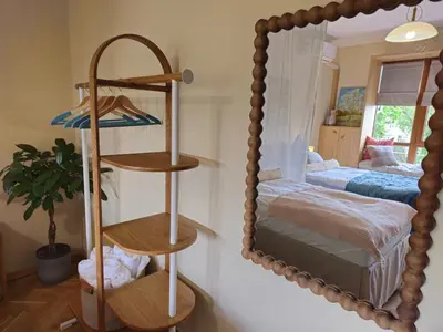 a large mirror in a bedroom with a bed at S íRMA Apartment - Amazing View of the Golden Domes in Sofia