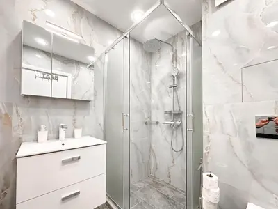a white bathroom with a shower and a sink at Crème Lux - Elegant 1BD in Manastirski Livadi by Flat Manager in Sofia
