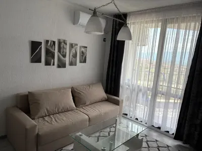 a living room with a couch and a glass table at Трушеви in Sandanski