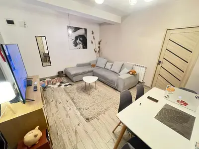 a living room with a couch and a table at Bulg Modern in Sofia