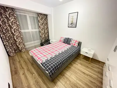 a small bedroom with a bed and a window at Bulg Modern in Sofia