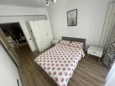 a bedroom with a bed with a polka dot blanket at Bulg Modern in Sofia