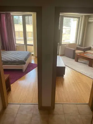 a room with a bed and a living room at Park Residence in Sofia