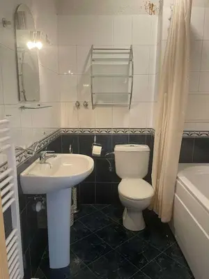 a bathroom with a toilet and a sink and a tub at Park Residence in Sofia