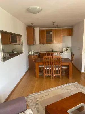a kitchen and dining room with a table and chairs at Park Residence in Sofia