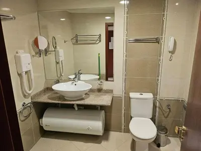 a bathroom with a sink and a toilet and a shower at Luxury apartment in Downtown Resort Bansko in Bansko