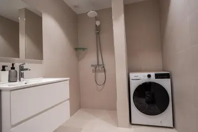 a washing machine in a bathroom with a sink at Stylish Apartment in City Center in Sofia