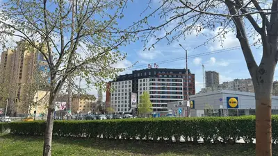 a city with tall buildings and trees and a hedge at Stylish Apartment in City Center in Sofia
