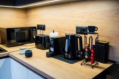 a kitchen counter with a coffee maker and a microwave at Stylish Apartment in City Center in Sofia