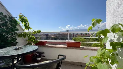 a balcony with a table and a view of a city at The Nest Above Sofia Studio in Sofia