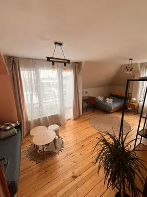 a living room with a couch and a table at The Nest Above Sofia Studio in Sofia