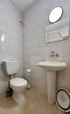a bathroom with a toilet and a sink and a mirror at The Nest Above Sofia Studio in Sofia