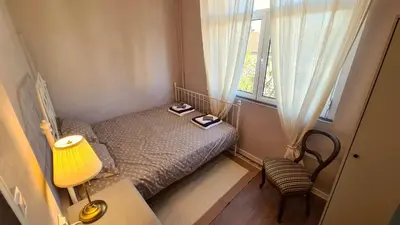 a small bedroom with a bed and a window at Bright 2-BDRM - Stunning Views - Sofia Center in Sofia