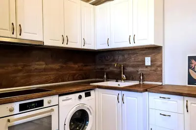 a kitchen with white cabinets and a washing machine at Bright 2-BDRM - Stunning Views - Sofia Center in Sofia