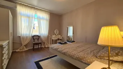 a bedroom with a bed with a lamp and a chair at Bright 2-BDRM - Stunning Views - Sofia Center in Sofia