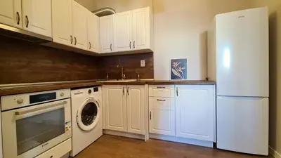 a kitchen with a white refrigerator and a dishwasher at Bright 2-BDRM - Stunning Views - Sofia Center in Sofia