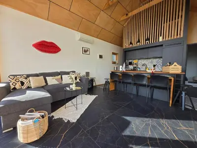 a living room with a couch and a bar at Villa Selya - Private Pool & Mountain View in Selyanin