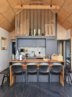 a kitchen with a large wooden table with chairs at Villa Selya - Private Pool & Mountain View in Selyanin