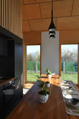 a large wooden table in a kitchen with windows at Villa Selya - Private Pool & Mountain View in Selyanin