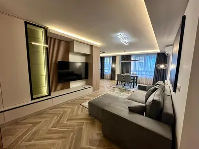 a living room with a couch and a flat screen tv at Milea apartments in Sofia