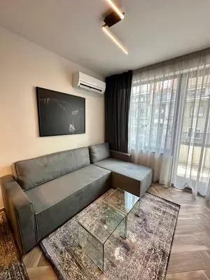 a living room with a couch and a flat screen tv at Milea apartments in Sofia