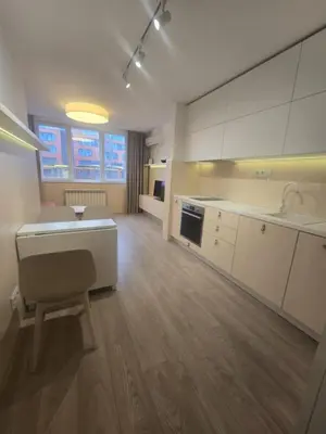 a large kitchen with white cabinets and a sink at Paradise Stay & private parking in Sofia